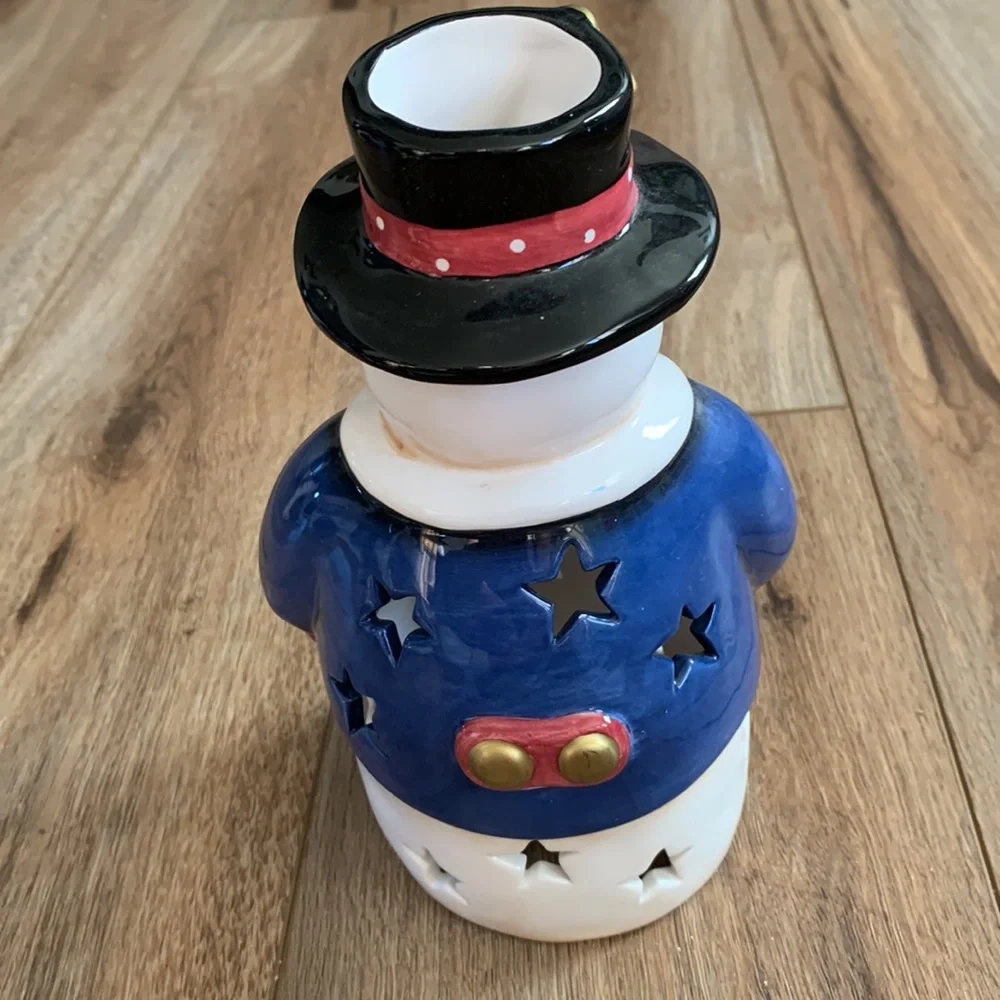 Snowman decor used as Christmas tree topper but think you can put light inside